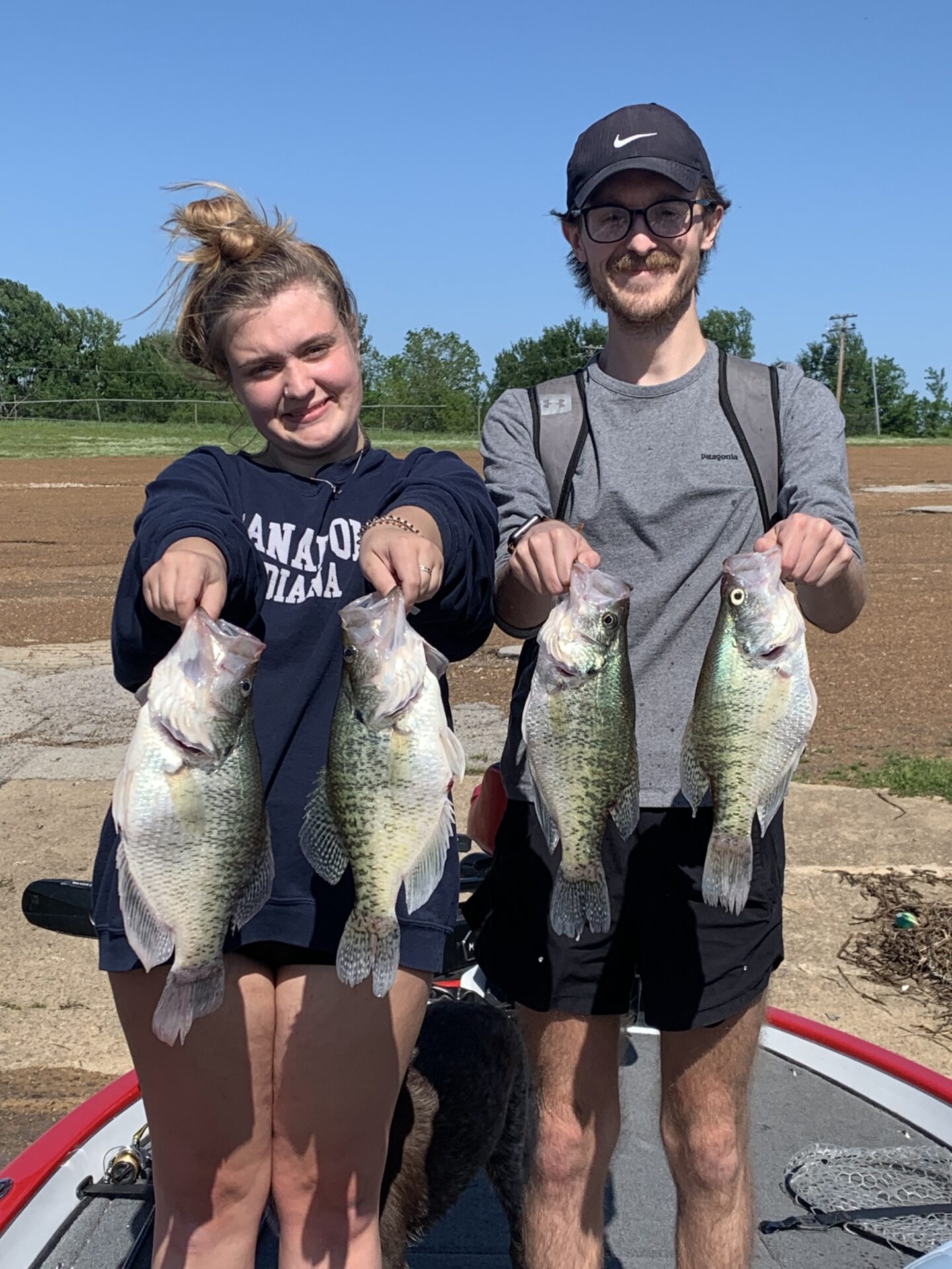 A couple holding fish on their hand