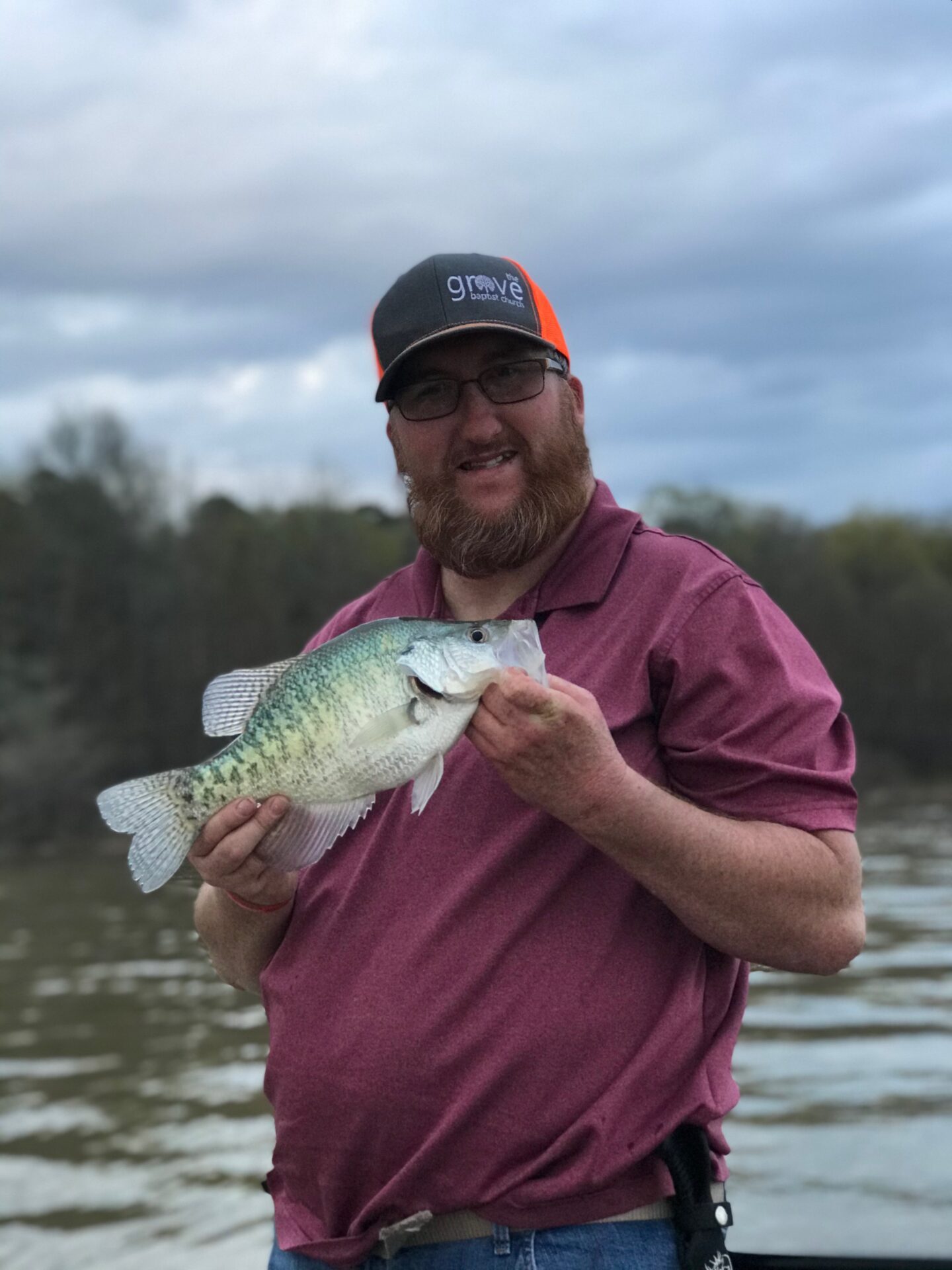 A man holding fish on his hand